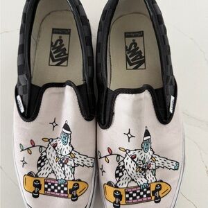 Vans White Canvas Slip-On Sneakers with Black Trim and Yellow Skateboard Graphic